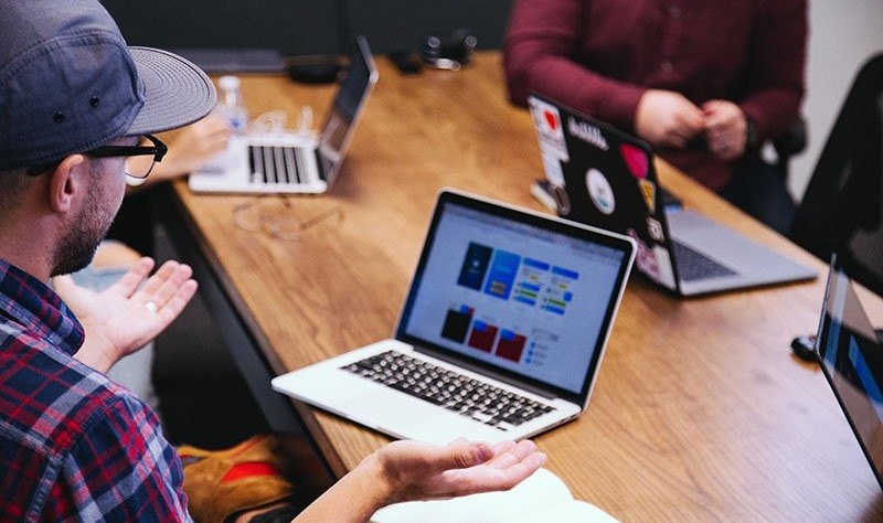 young man checking for something on a laptop